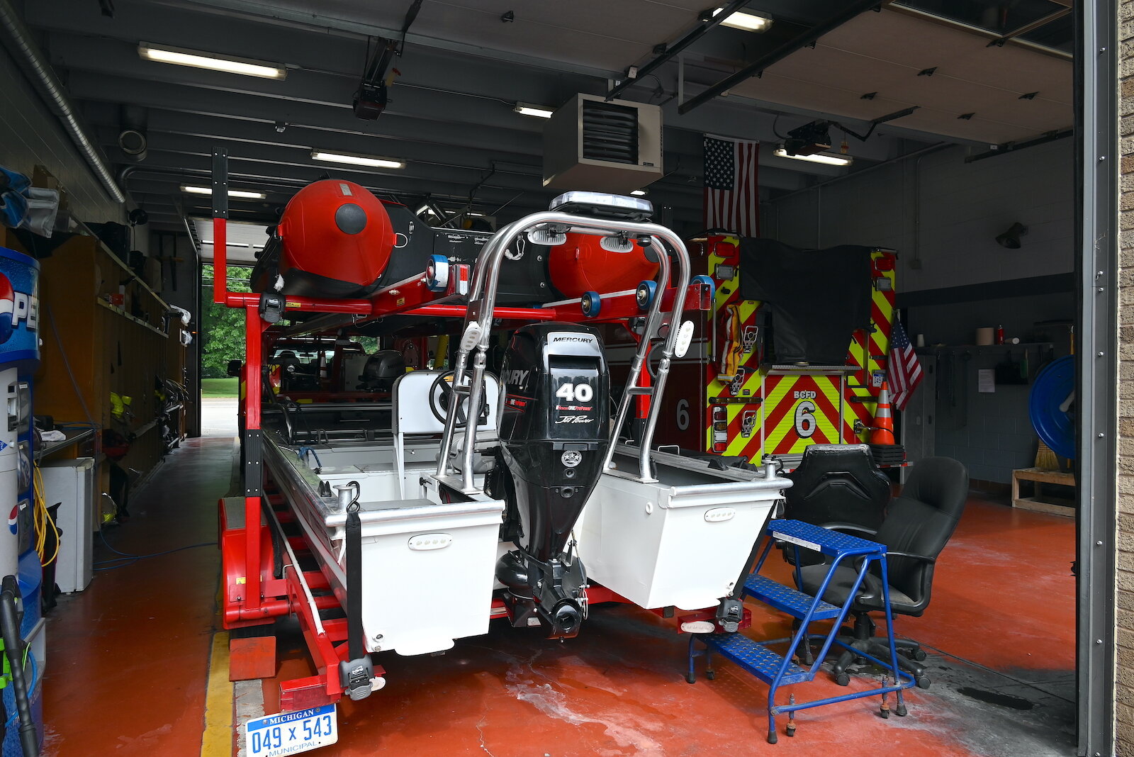 Two boats are parked inside Fire Station #6