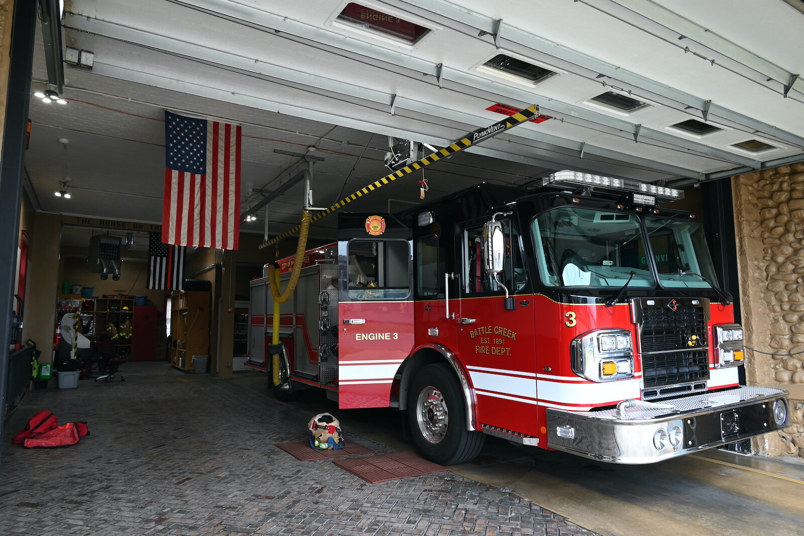 A fire truck is parked in a bay at Fire Station #3.