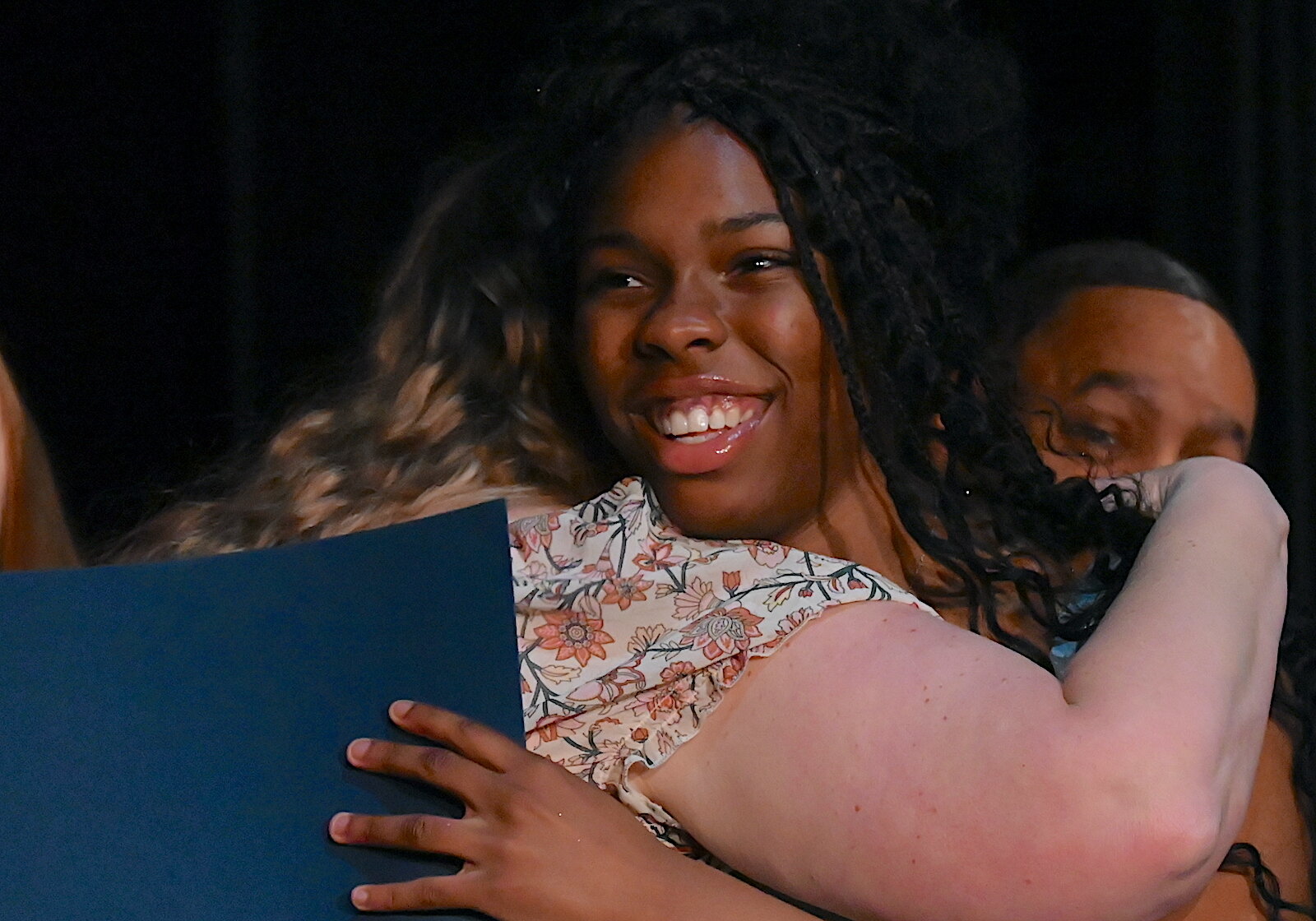 Battle Creek Public School’s STEM Innovation Center eighth grade graduate Akari Davis hugs a faculty member during graduation ceremonies.