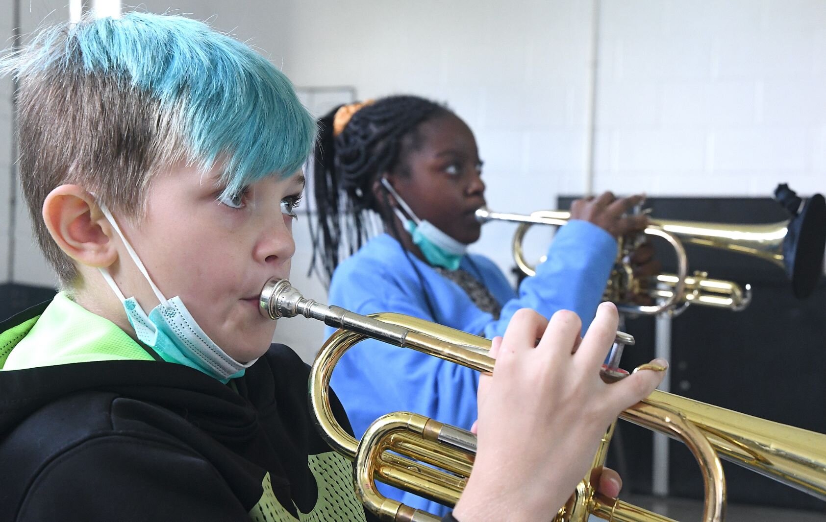 Braylen Bushee-Holcomb, left, and Sylvia West, sixth grade students at Northwestern Middle School practice their trumpets in music class.