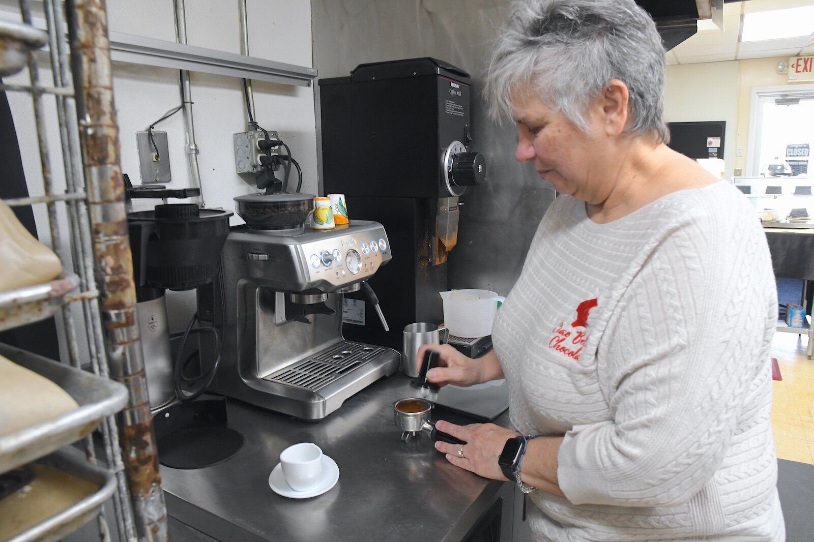 Karen Pacella, owner of Ciao Bella Chocolat, prepares an espresso. 15-16 Raw cacao beans from Uganda.