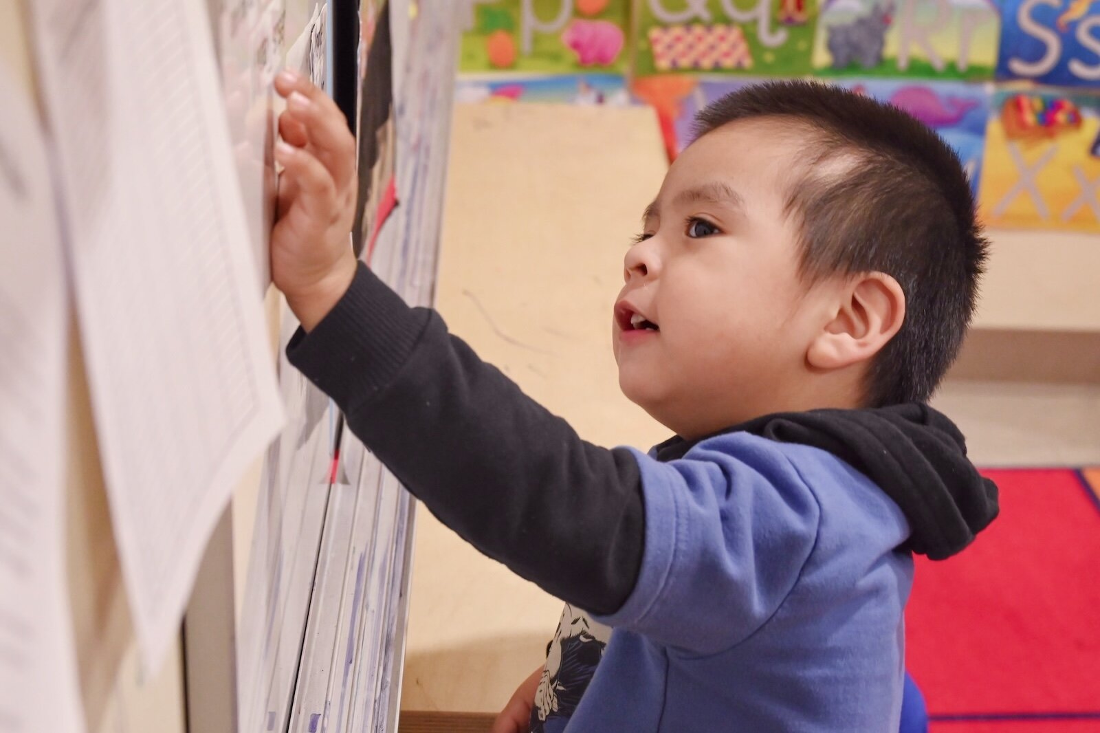 Jesus Tapia puts a correct answer on a white board at LaEscuelita International Bilingual Early Childhood Education Center operated by VOCES on West Michigan Avenue.