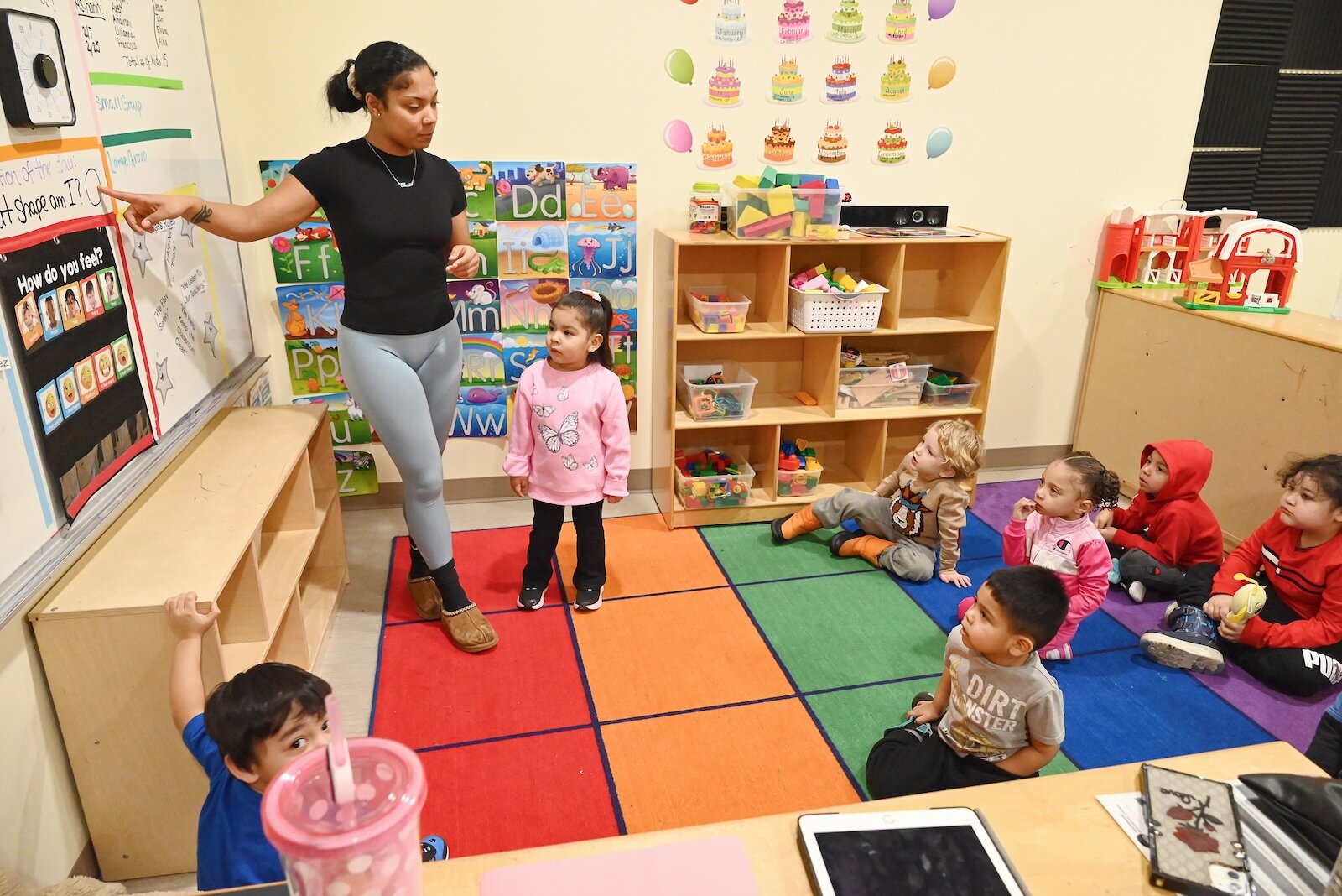 Cheria Richardson, lead teacher at LaEscuelita International Bilingual Early Childhood Education Center, is seen with a group of young children.