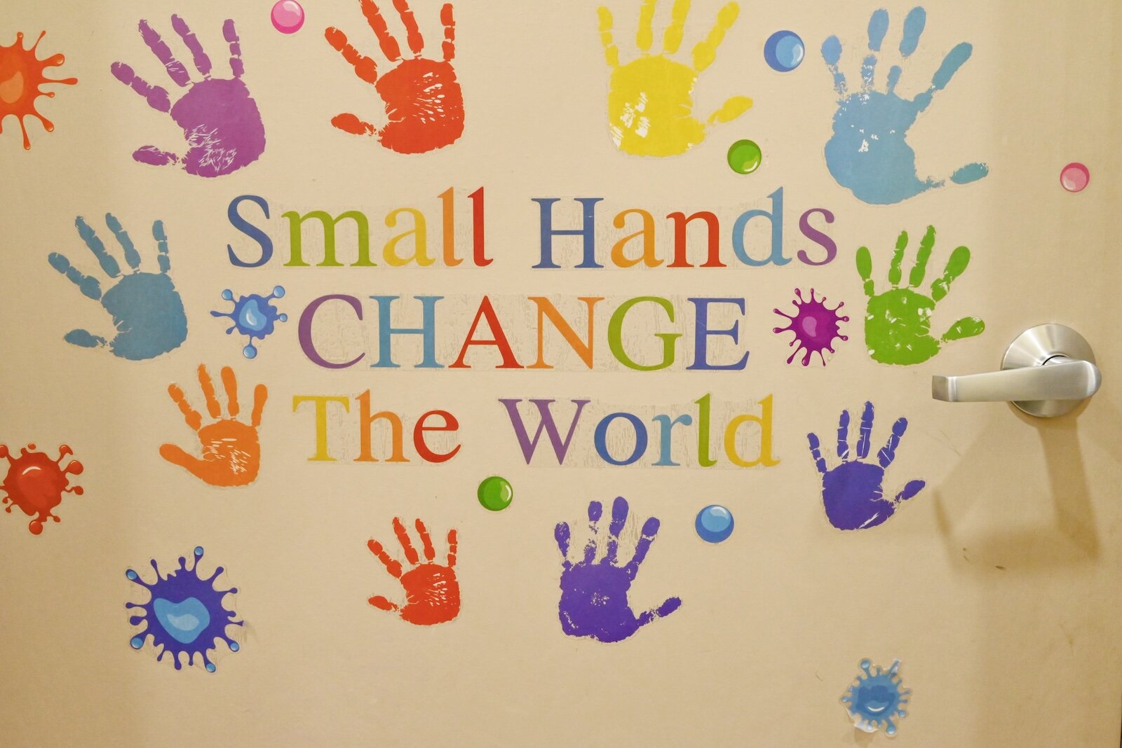 Small Hands Change The World” saying on a door at LaEscuelita International Bilingual Early Childhood Education Center operated by VOCES