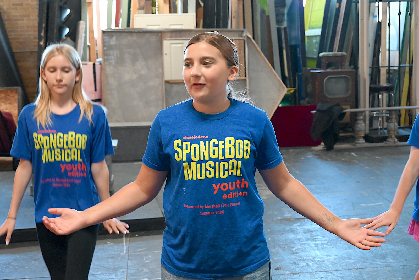 Dede Weaver, left, and Kinlee Dermeyer rehearses a dance scene for the Marshall Civic Players production of “The SpongeBob Musical-Youth Edition.”