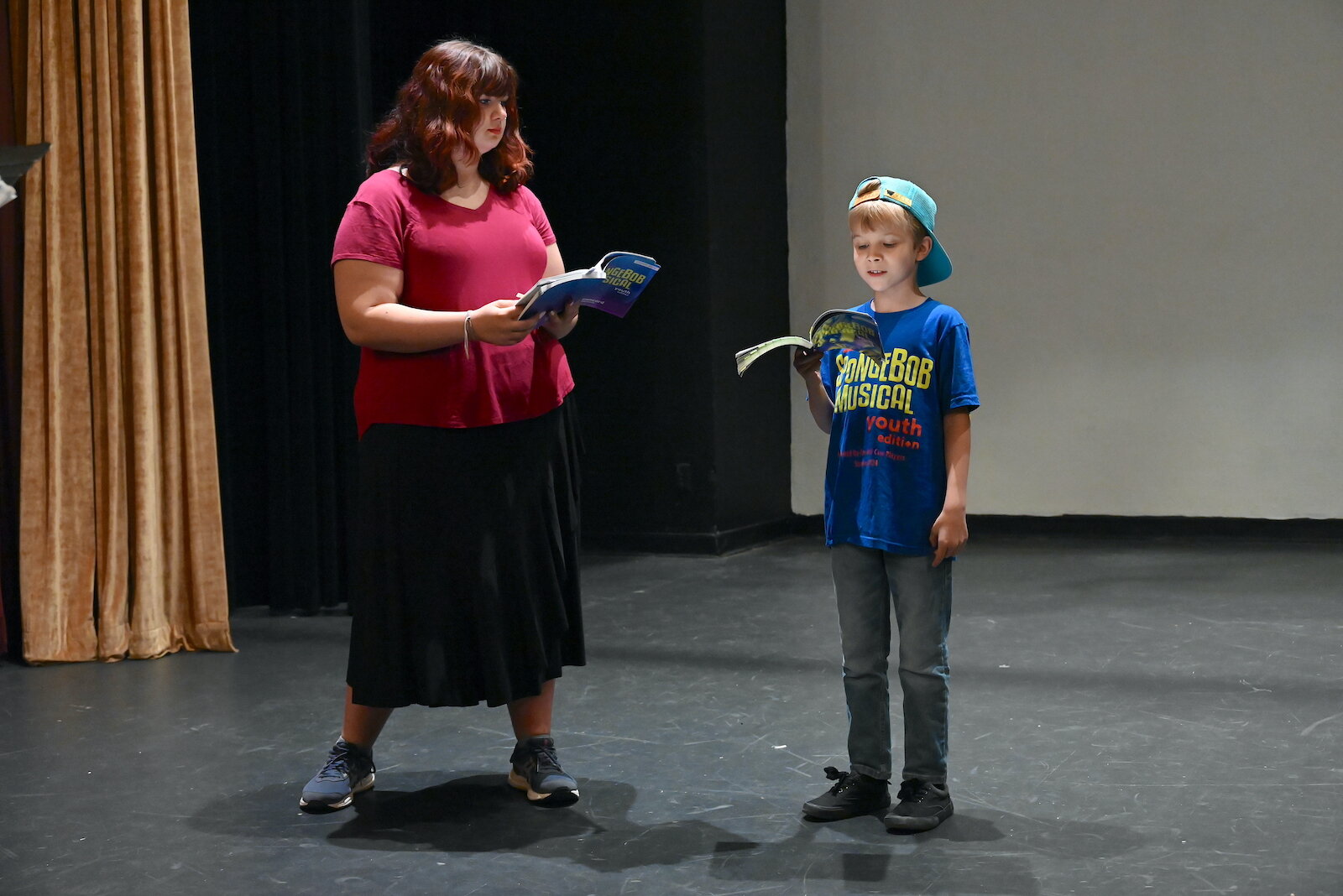 Aurora Dangerfield, left, and Lincoln Weaver rehearse a scene for the Marshall Civic Players production of “The SpongeBob Musical-Youth Edition.”