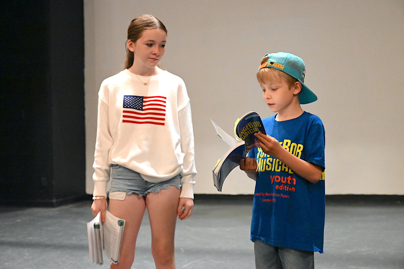 Nety Figueredo, left, and Lincoln Weaver rehearses a scene for the Marshall Civic Players production of “The SpongeBob Musical-Youth Edition.”