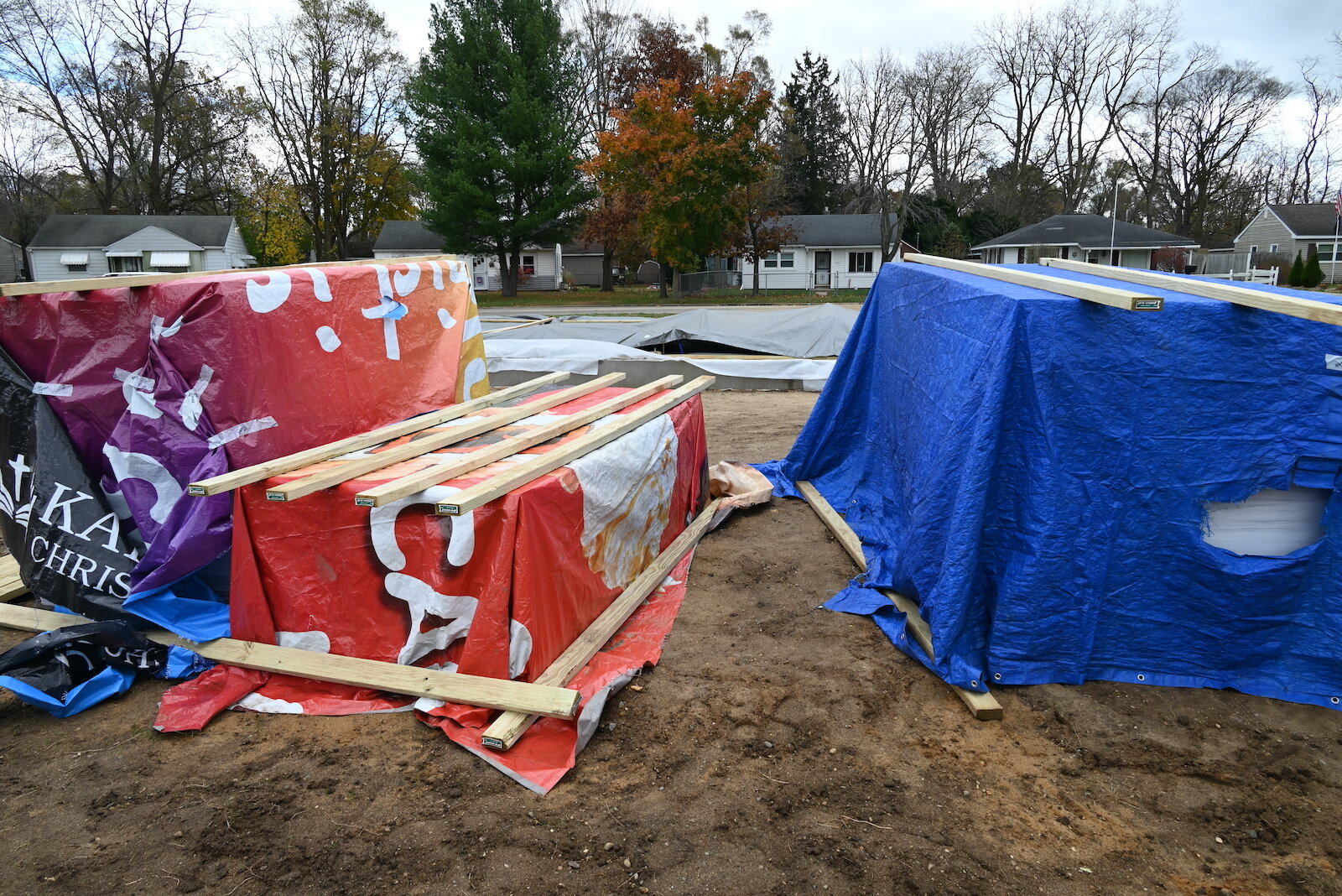 Building supplies for houses under construction near LaMora Park Elementary are kept under tarps.