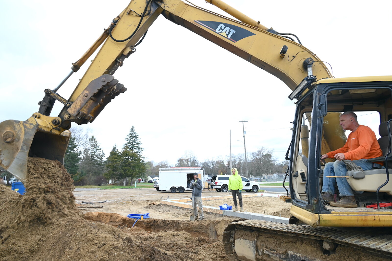 Russ Baker of R.A. Baker Plumbing and his backhoe move soil on a Habitat for Humanity construction site near LaMora Park Elementary.