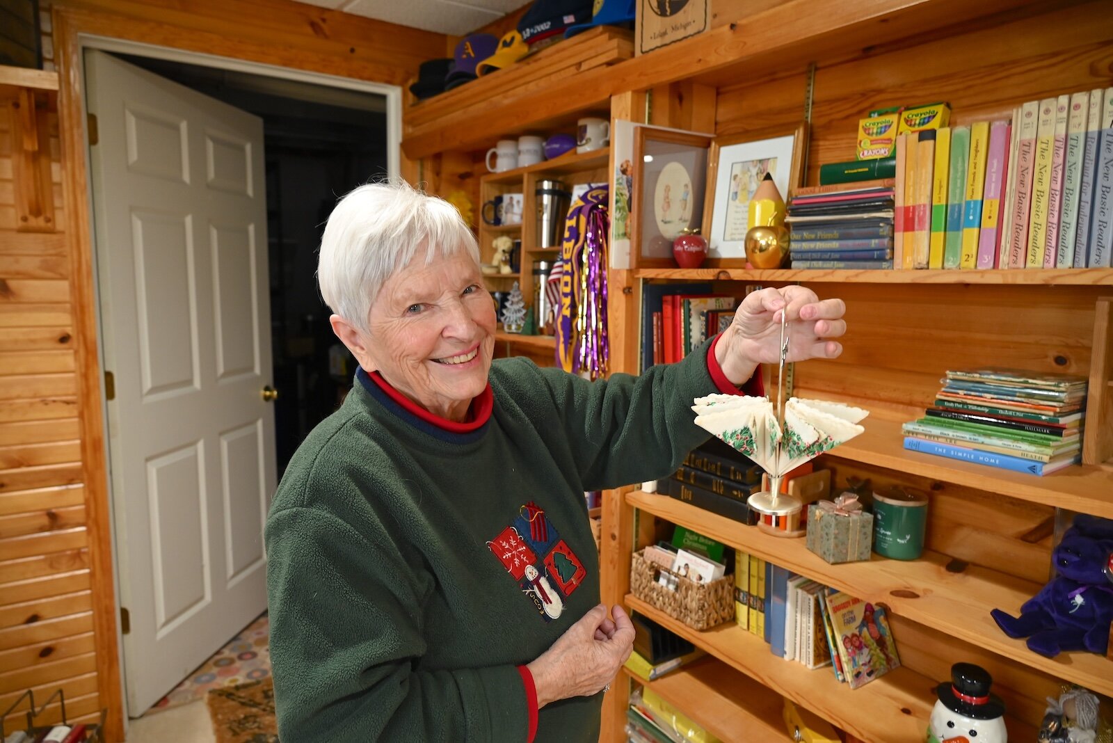 Cathy Campbell holds a napkin holder she received from her friend Jim Dean.