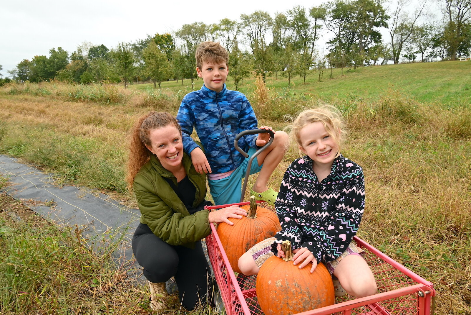 Kate Antoniotti and her children Leo and Rose pose with the pumpkins the chose during Of The Land’s harvest festival.