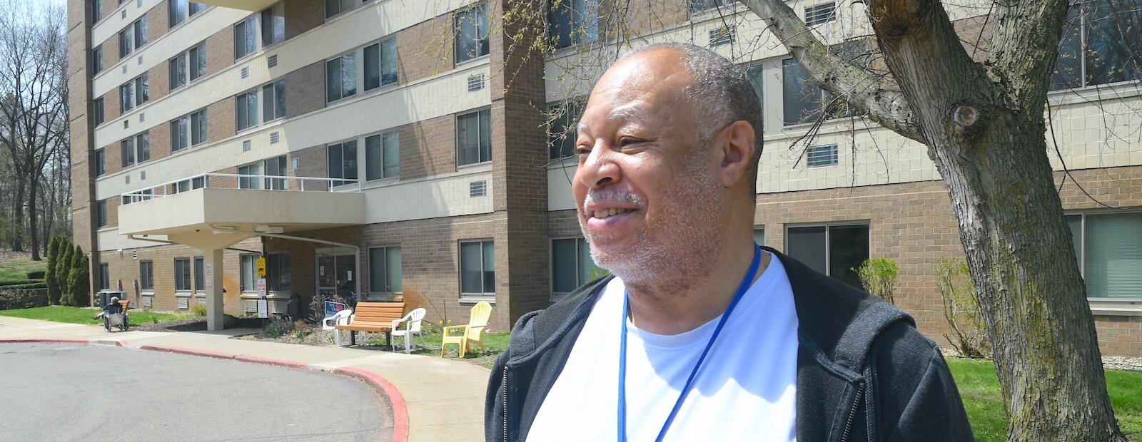 Lowell Wilson stands outside the Springview Tower apartment complex.