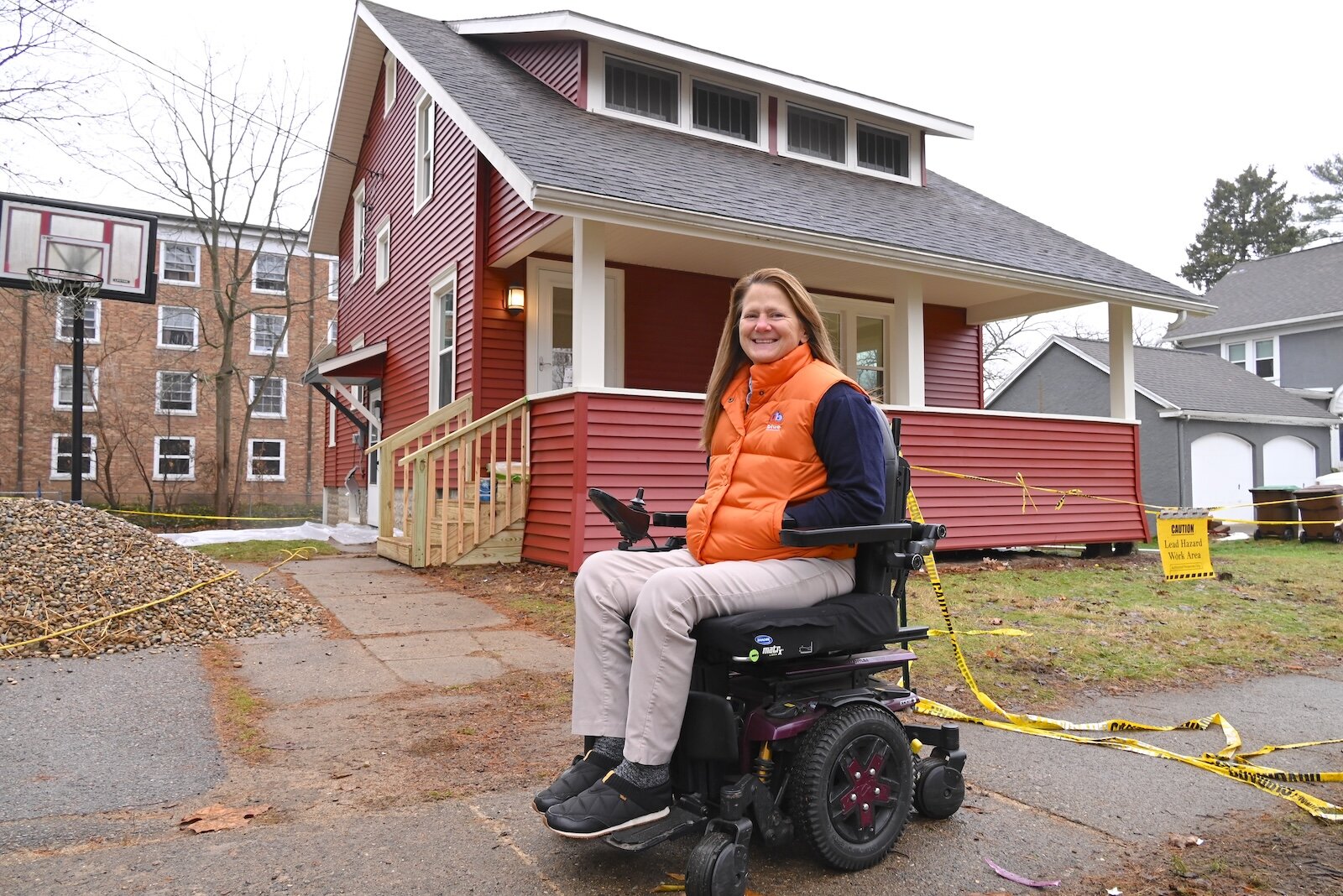 Staci Stuart of Urban Blue Development is in front of a house in Albion being renovated to remove lead.