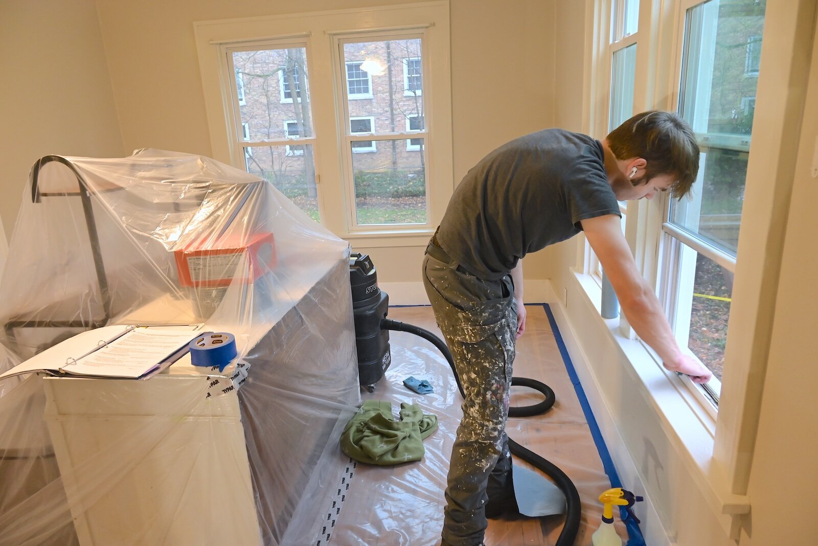 Landon Seal works on windows in a house in Albion being being renovated to remove lead.