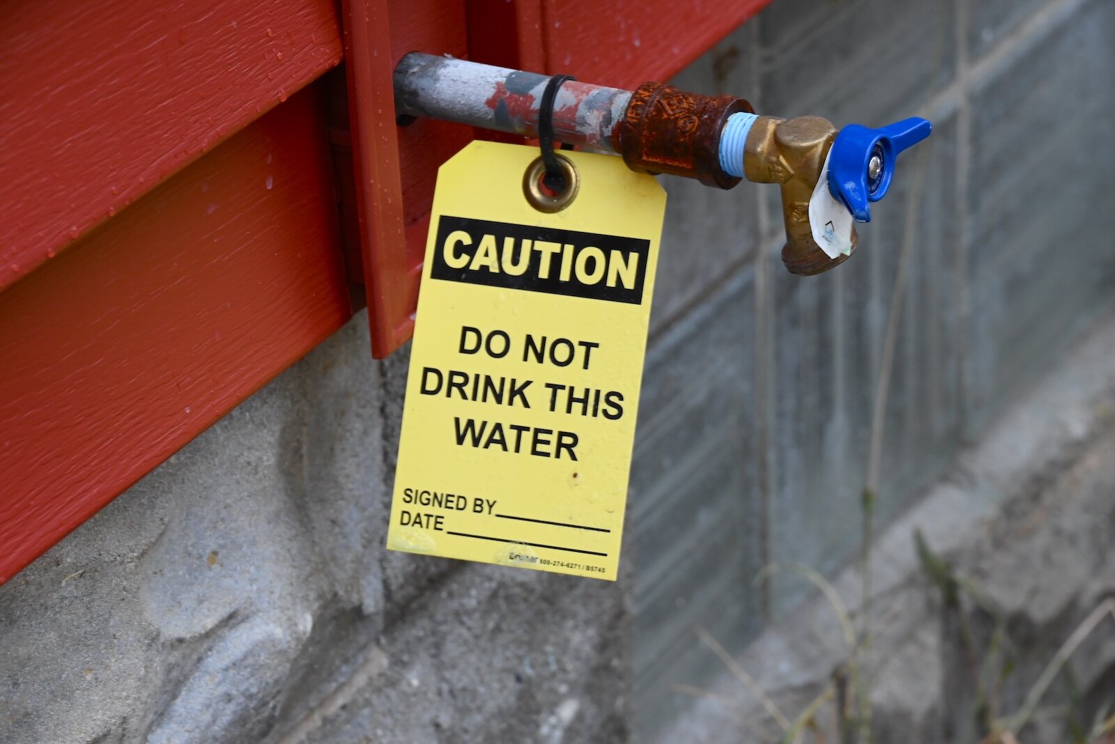 Warning on an outside faucet at a house in Albion being renovated to remove lead