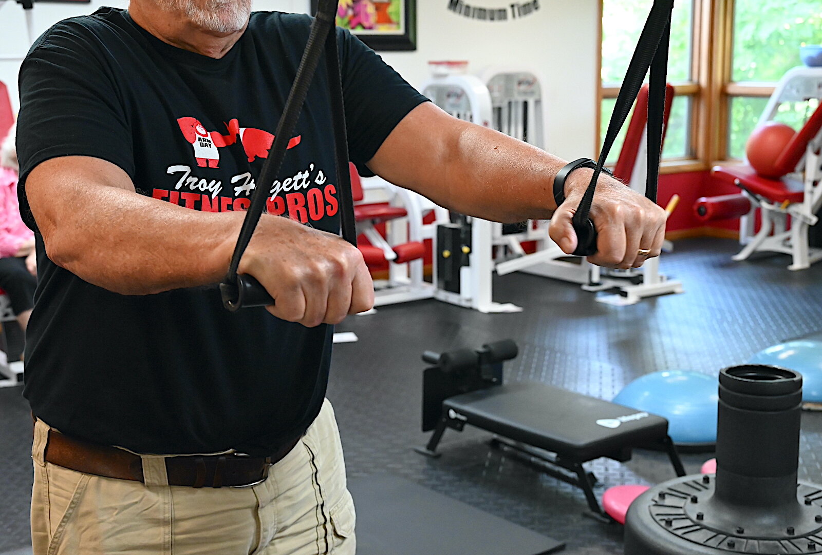 Troy Huggett stands in the workout room of his fitness business.