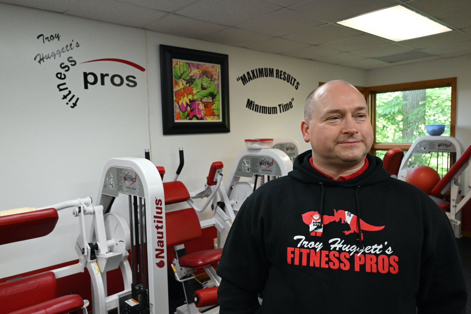 Troy Huggett stands in the workout room of his fitness business.