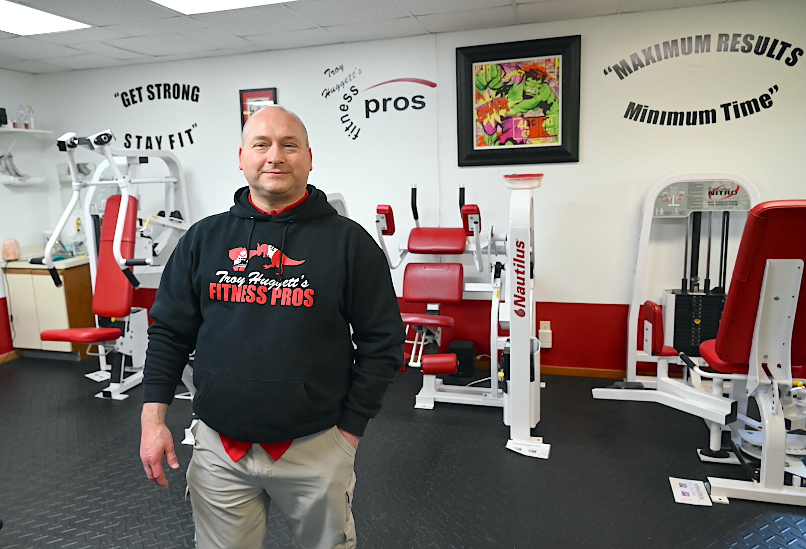 Troy Huggett stands in the workout room of his fitness business.