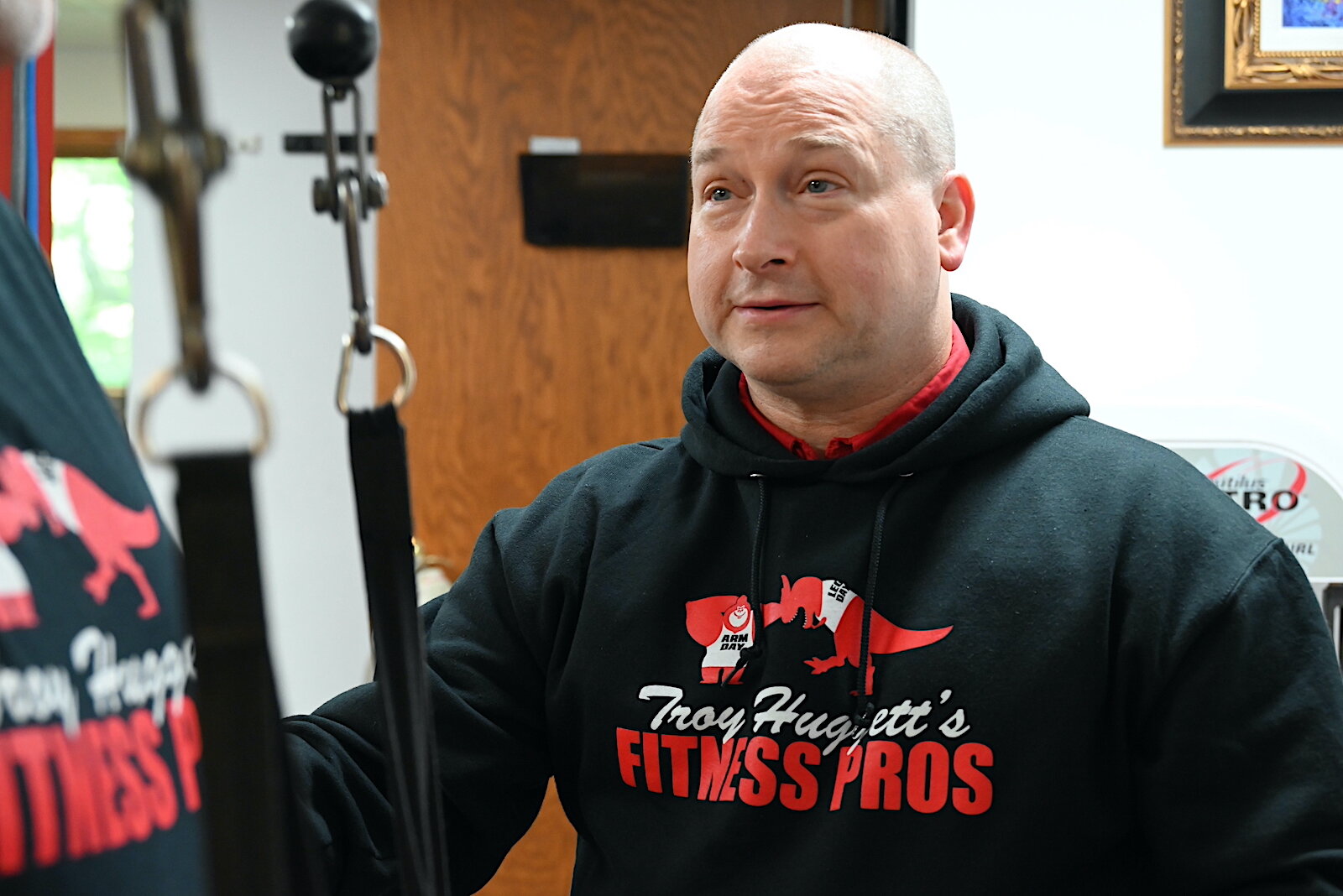 Troy Huggett stands in the workout room of his fitness business.