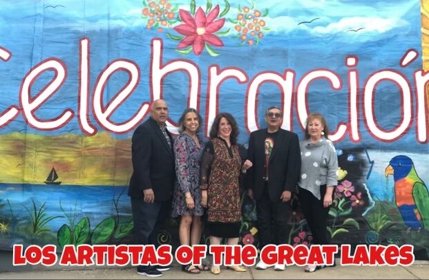 Los Artistas of the Great Lakes stand together in front of a mural located in front of Torti Taco that they all painted. Standing from left to right: Fausto Fernandez, Xenia Rose Schafer, Coco Sweezy, George Martinez and Carol Bueno.