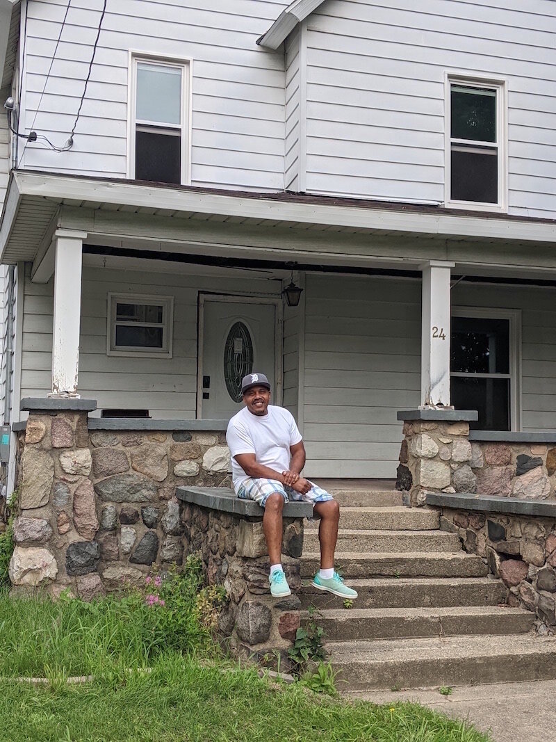 Raul Maysonet, founder and pastor of Hood Church, sits near the entrance of Hope House.