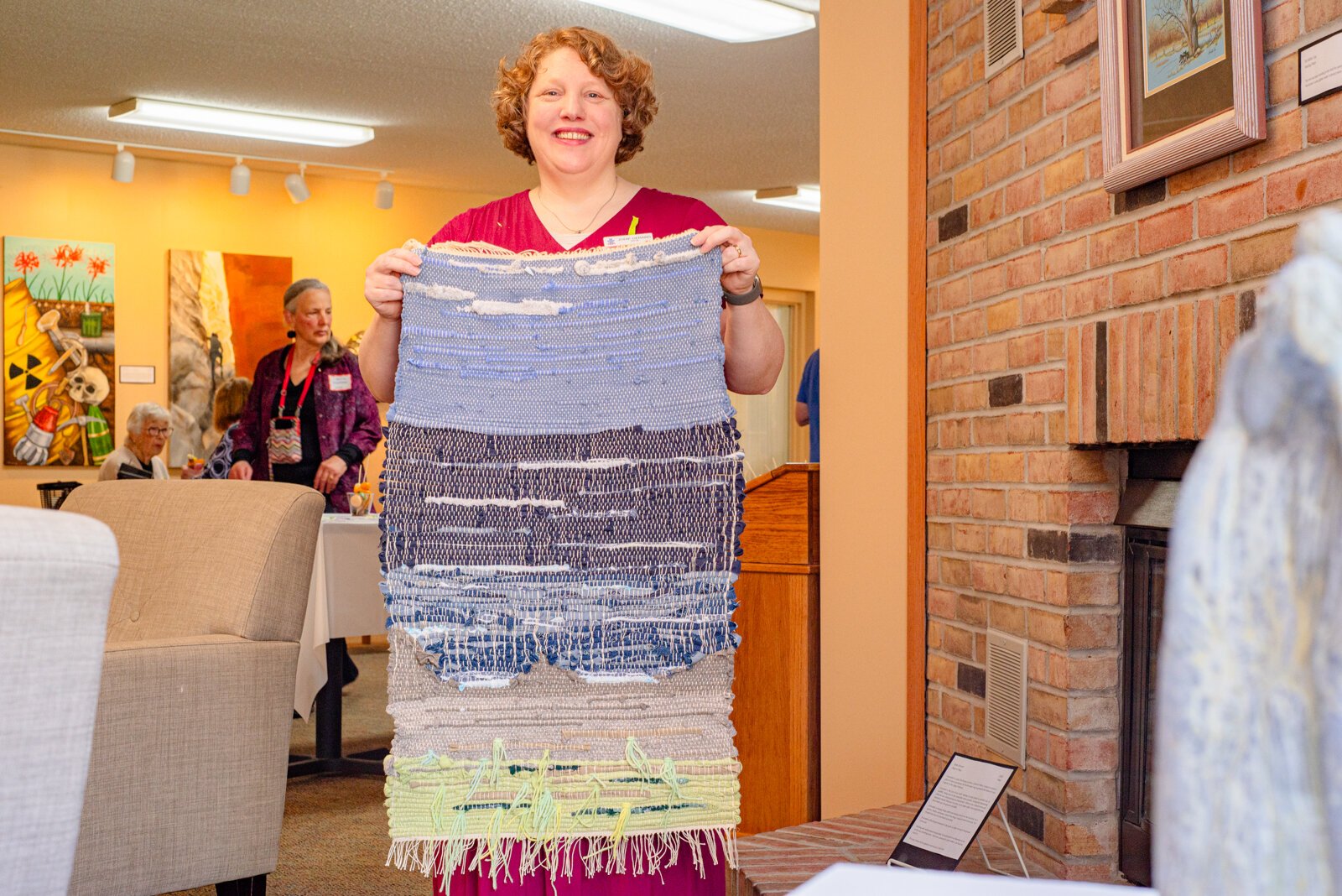 Artist, Jodie Gerard with her piece "Rags to Rugs."