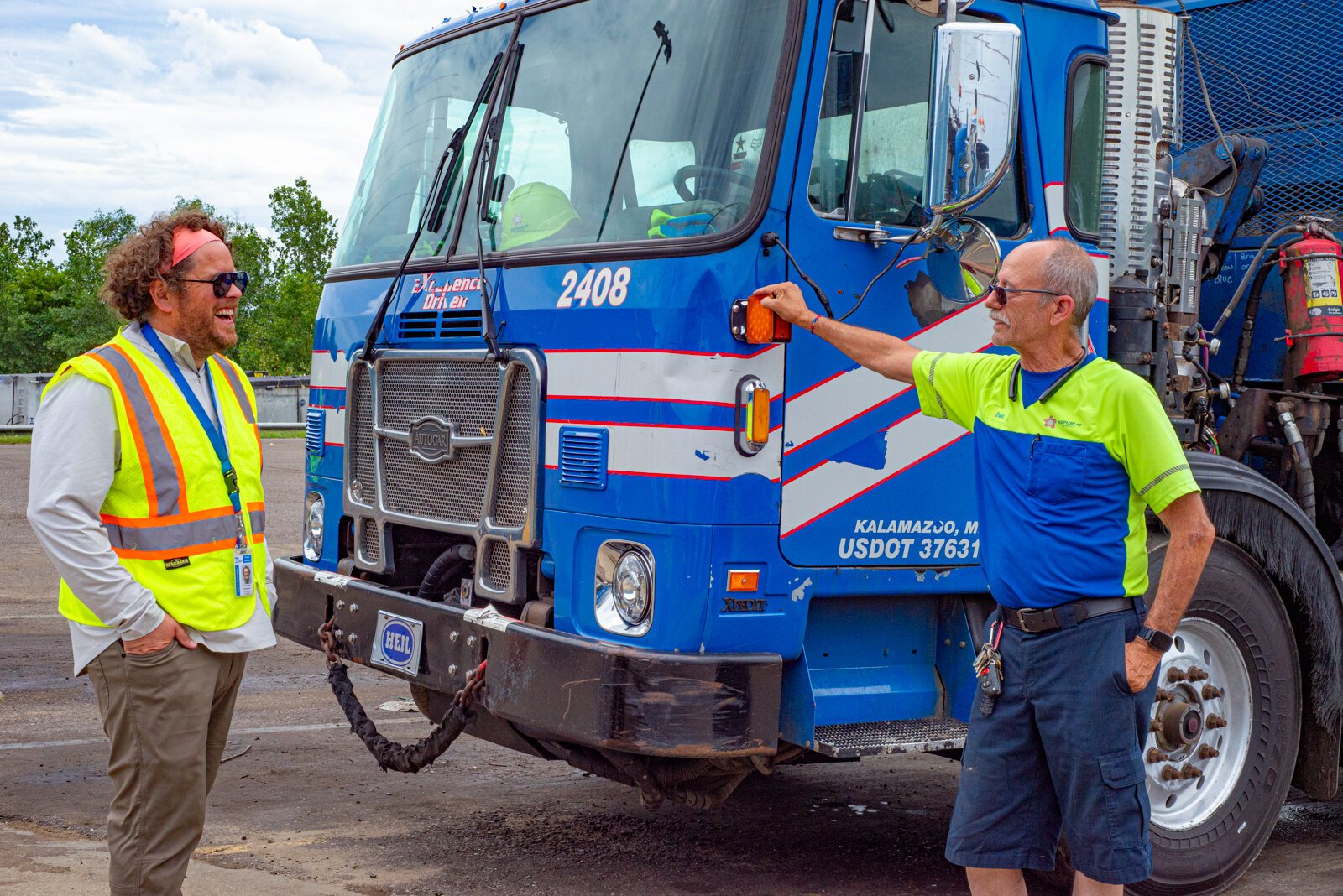 Chris Broadbent, City of Kalamazoo's Solid Waste Coordinator, and Dale Mentor, Kalamazoo's recycling driver, talk shop.