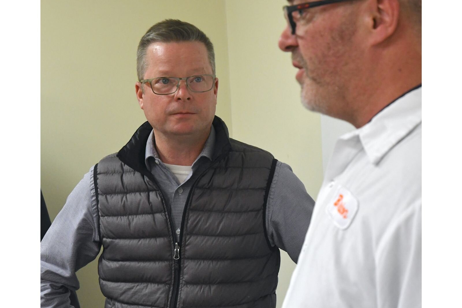 John Hart of the City of Battle Creek listens to Brandon Hultink of Snackwerks.