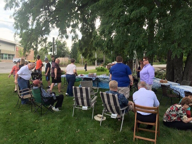 Before the COVID-19 pandemic prevented large in-person meetings, it was not unusual for neighbors to have barbecues and get-togethers. Stuart Area residents are shown at West Main Park, one of the city's oldest and smallest public parks. 