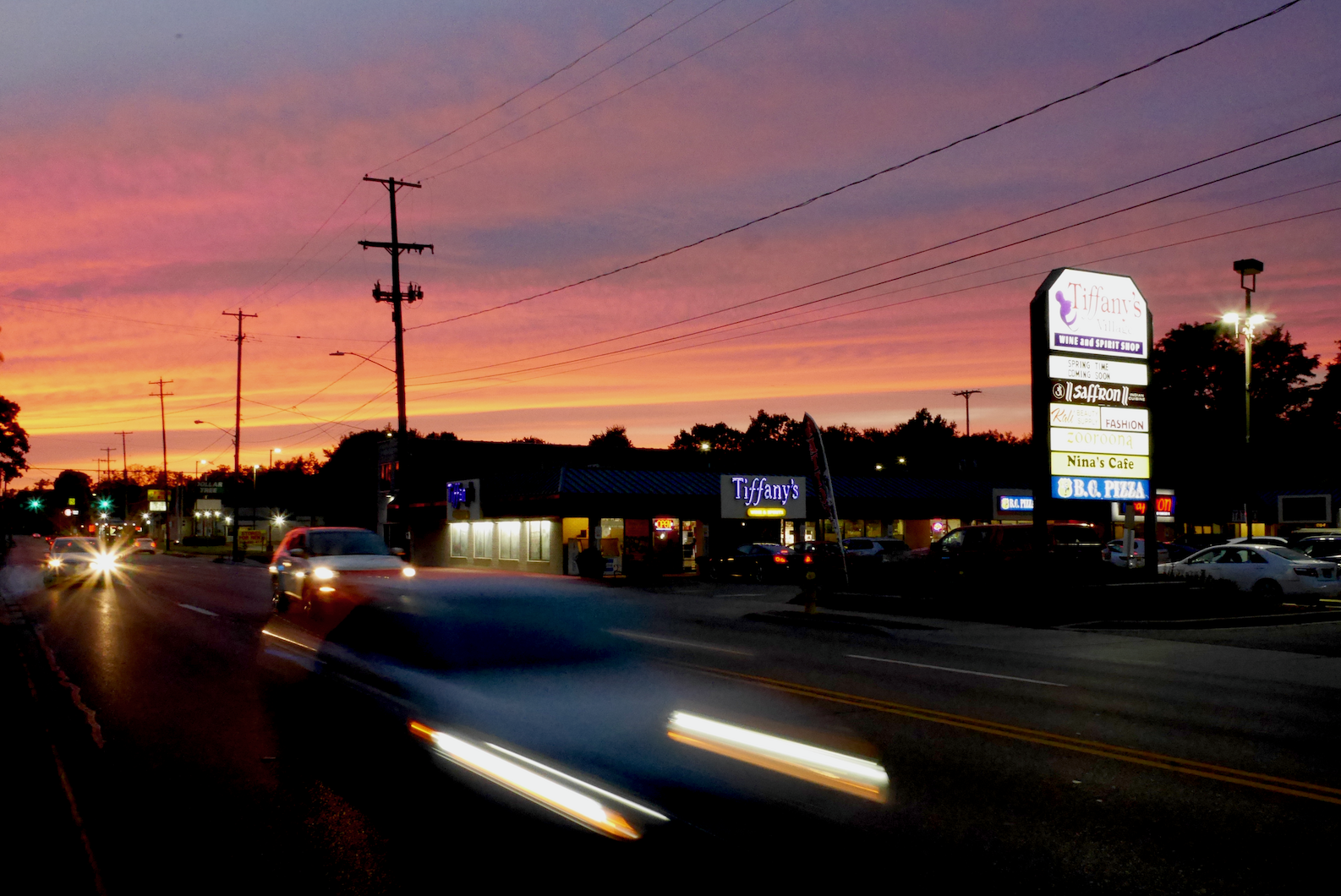 A night shot of West Main near Tiffany's Wine & Spirits