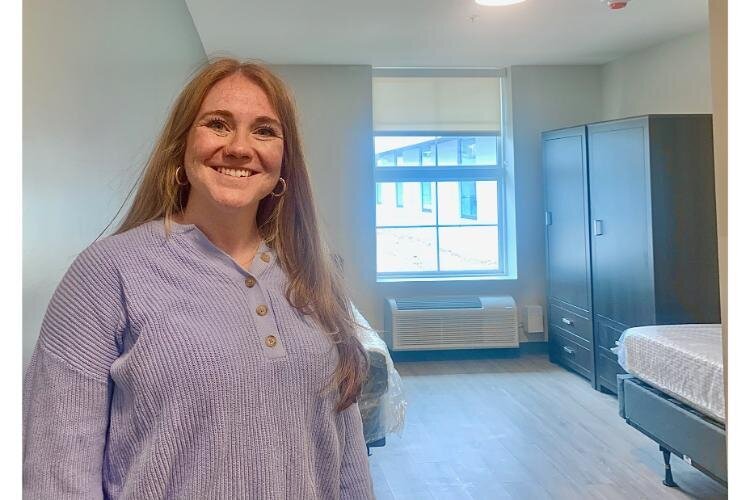 Local manager Blaire Zielke stands in a one-person room at Enlightened Recovery of Kalamazoo.