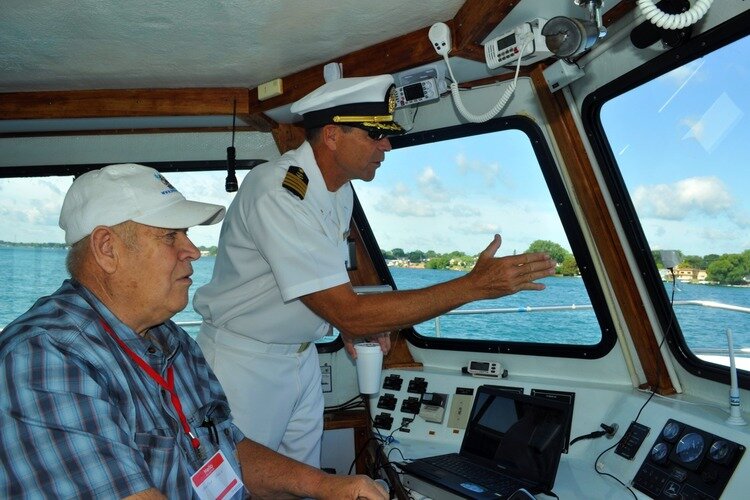 Captain speaking to one of the veterans aboard at a previous Boat4Vets event.