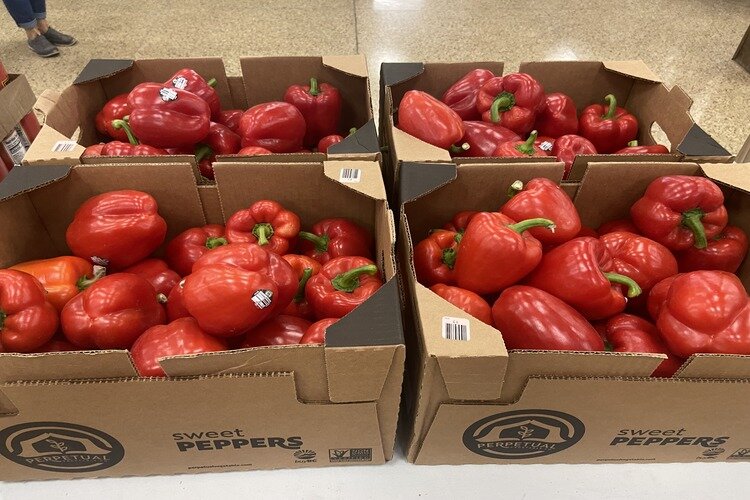 Boxes of red peppers given out to families in need.