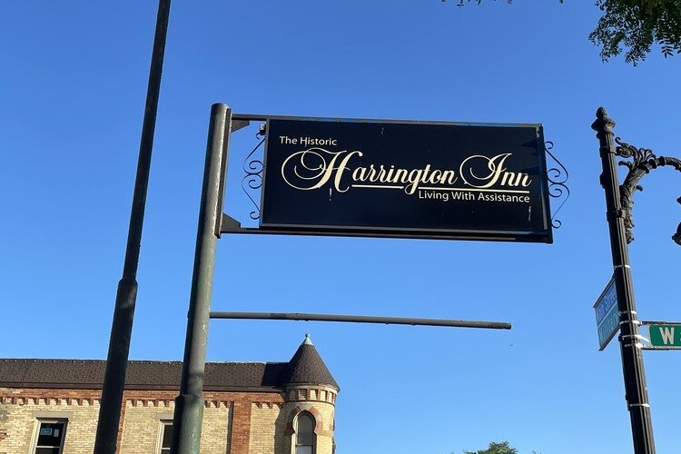 Sign stating "Historic Harrington Inn, Living with Assistance." 