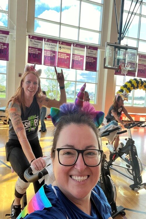 InSHAPE staff Erin Sullivan and Erika Rice participate in a spin class at the YMCA .