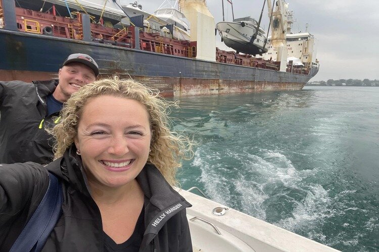 Nicole (front) and James Christie watching a yacht being transported by freighter to another port.