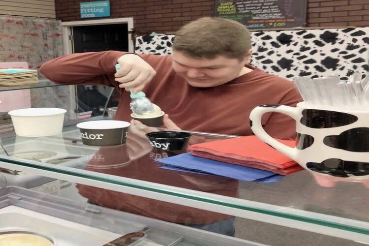 Jeffrey Anger scooping ice cream.