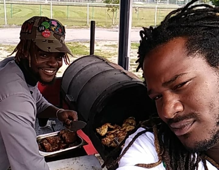 Chef Adrien Lee (left) and Mark Pack get a head start on making food for the Jamaican Jerk food truck.