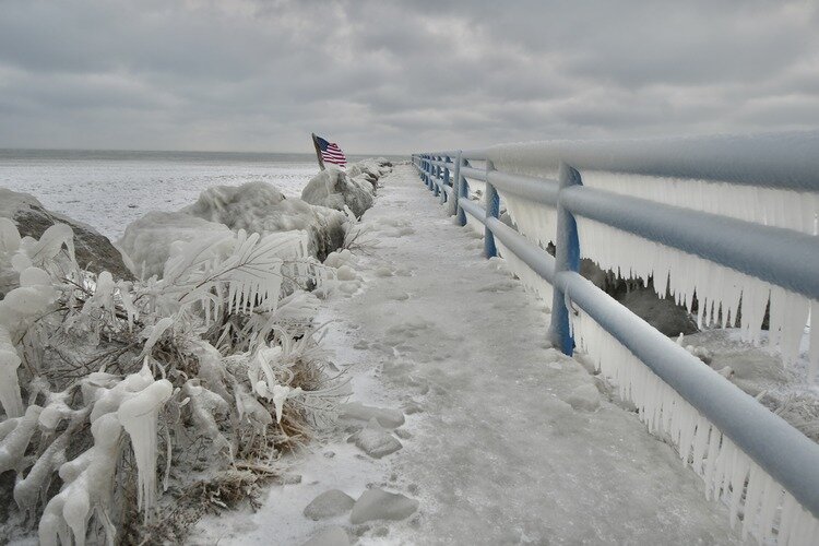 The pier on Lexington Harbor is sculpted with ice.