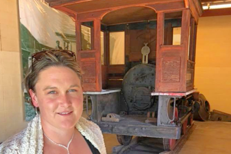 Margaret Aiken with the Daniel B. Harrington steam locomotive.