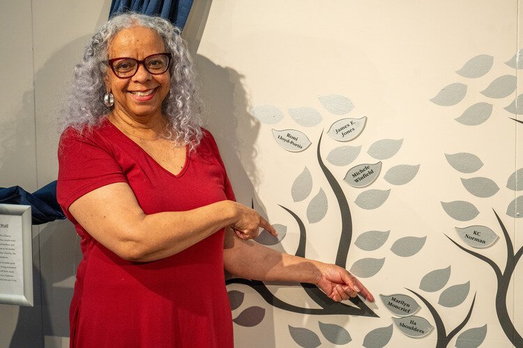 Marilyn Moncrief points out her name on the Stanley Legacy Wall.