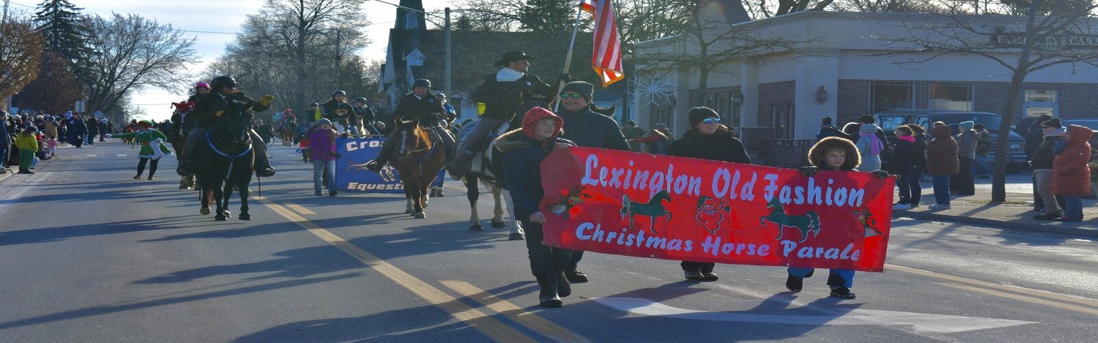 A bold, crimson banner announces the start of the parade.