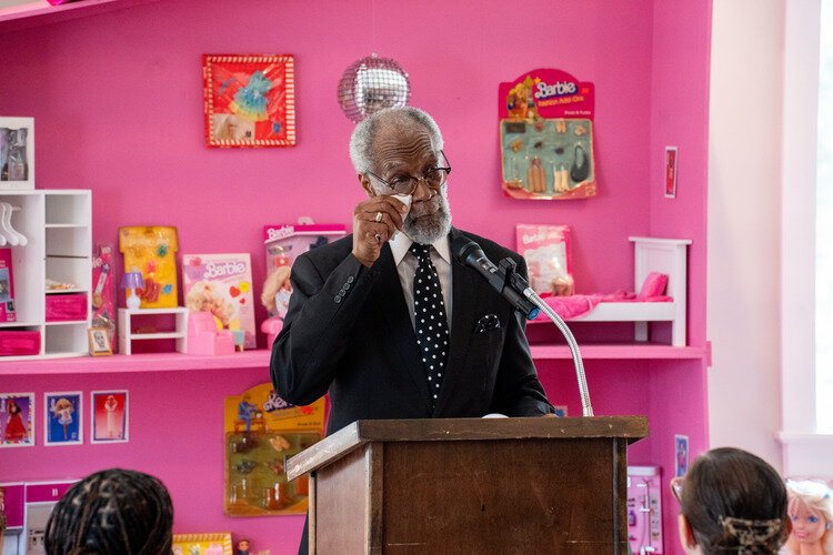 Pastor Carl Miller Sr. wipes away tears from the joy and surprise of being inducted into the Stanley Legacy Wall.