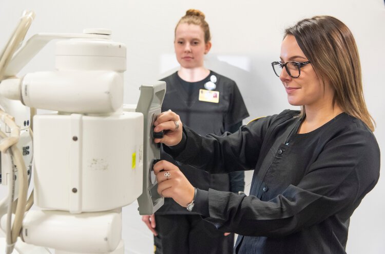 Students learn how to use a portable X-ray machine