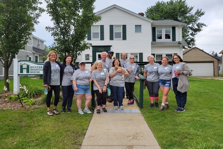 2023's Rock the Block event volunteers standing behind the Hunter Hospitality House in Port Huron.