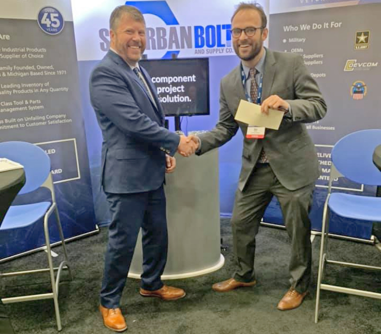 Eric Peterson congratulates a winner during MDEX 2019.