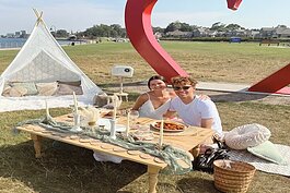 Jazmyn Vitro (left) Kanye Cole (right) enjoy a date for two in front of the new sculpture at Thomas Edison Parkway.