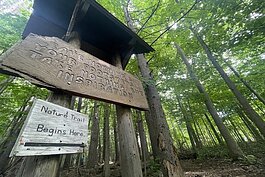 A sign at the start of the Michigan Nature Association trail reads "Leave nothing but your footsteps. Take nothing but inspiration"