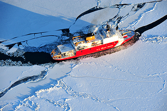 Breaking through the ice is a Coast Guard cutter. 