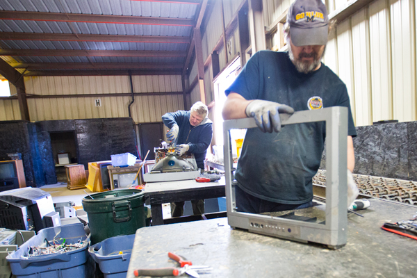 Workers recycle TVs at Sgt's Recycling.